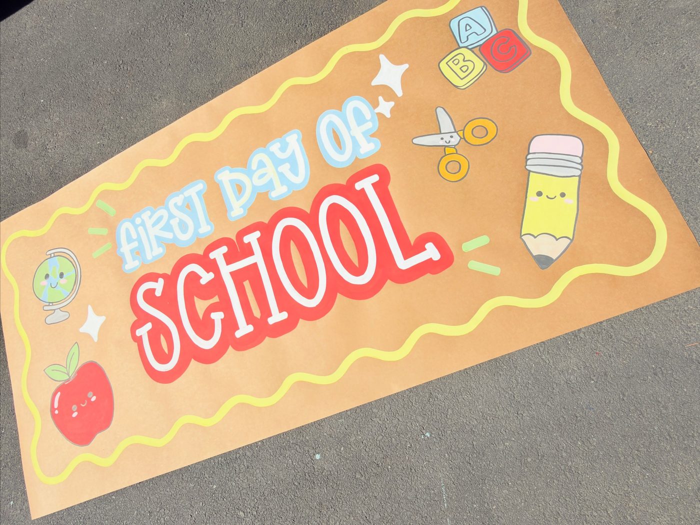 First day of school banner with apple, pencil, and SCHOOL lettering by Katie Paige Art Co